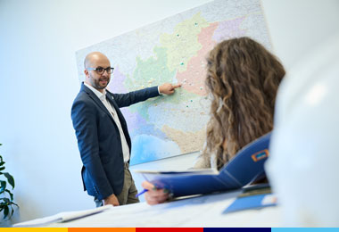 Collaboratori ALDI Sviluppo Immobiliare in ufficio con cartina geografica