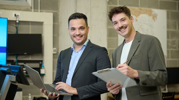 Dipendenti ALDI sorridenti che controllano i dati al computer